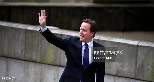 Britain's Prime Minister David Cameron waves on arrival to meet with Leader of the Scottish National Party , Alex Salmond at St Andrews House, in...