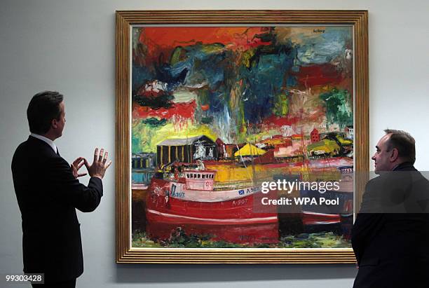 New British Prime Minister Prime Minister David Cameron talks to Scottish First Minister Alex Salmond as they stand in front of the painting,...