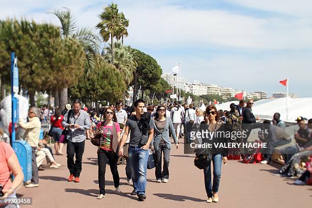 People walk on the Croisette near the Palais des Festivals during the 63rd Cannes Film Festival on May 14, 2010 in Cannes. Picture taken with a tilt...