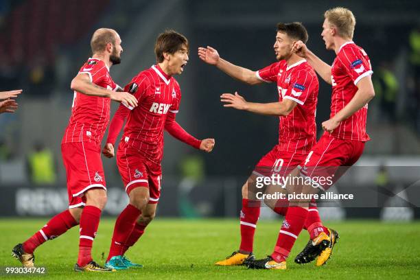 Cologne's Yuya Osako , Konstantin Rausch, Salih Oezcan and Frederik Soerensen cheer over the former's 2-2 score during the Europa League group H...