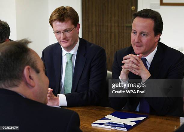 New British Prime Minister Prime Minister David Cameron sits opposite Scottish First Minister Alex Salmond, as and Scottish Secretary Danny Alexander...