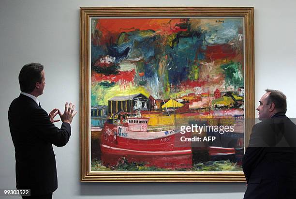 New British Prime Minister Prime Minister David Cameron talks to Scottish First Minister Alex Salmond as they stand in front of the painting,...