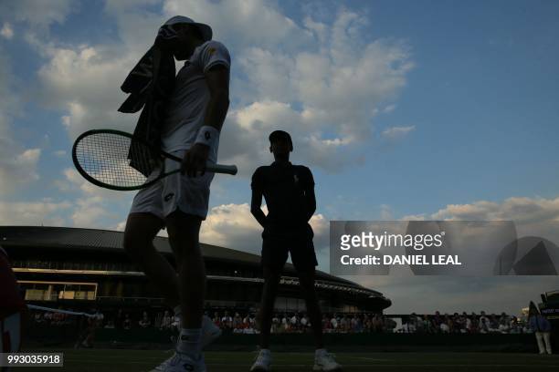 Argentina's Guido Pella dries his face as he plays US player Mackenzie McDonald during their men's singles third round match on the fifth day of the...