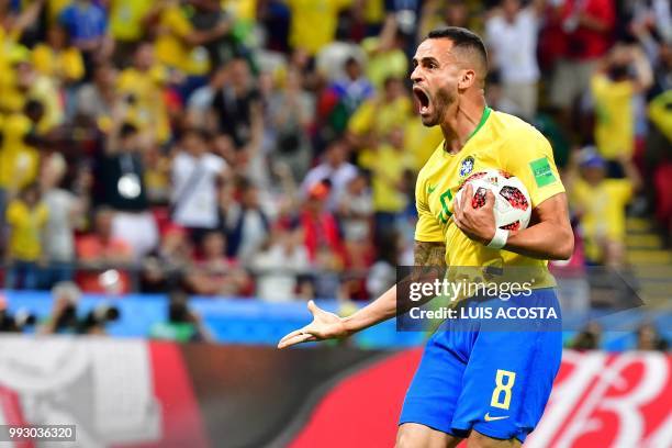 Brazil's midfielder Renato Augusto reacts after scoring his team's first goal during the Russia 2018 World Cup quarter-final football match between...