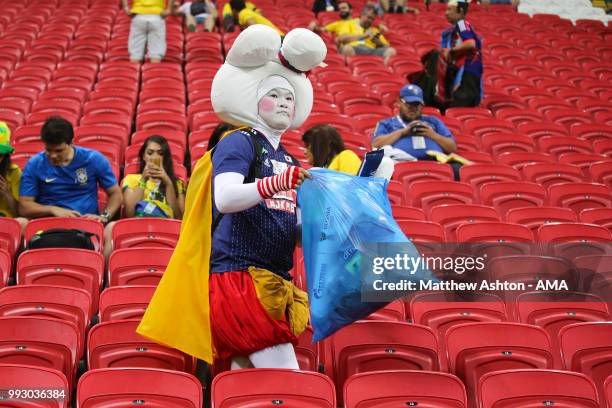 Fan of Japan cleans up rubbish at the end of the 2018 FIFA World Cup Russia Quarter Final match between Brazil and Belgium at Kazan Arena on July 6,...