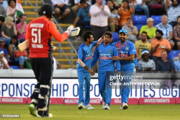 India's Kuldeep Yadav is congratulated after making a catch to dismiss England's Jonny Bairstow during the international Twenty20 cricket match...