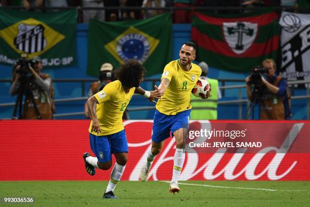 Brazil's midfielder Renato Augusto celebrates, with Brazil's defender Marcelo , after scoring during the Russia 2018 World Cup quarter-final football...