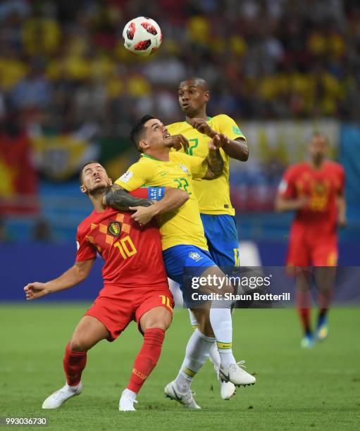 Eden Hazard of Belgium is challenged by Fagner and Fernandinho of Brazil during the 2018 FIFA World Cup Russia Quarter Final match between Brazil and...