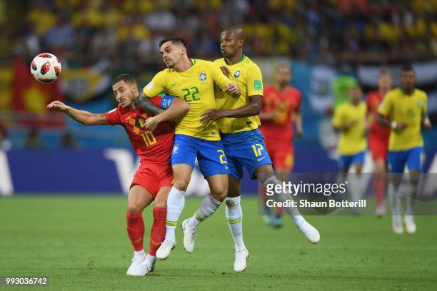 Eden Hazard of Belgium is challenged by Fagner and Fernandinho of Brazil during the 2018 FIFA World Cup Russia Quarter Final match between Brazil and...