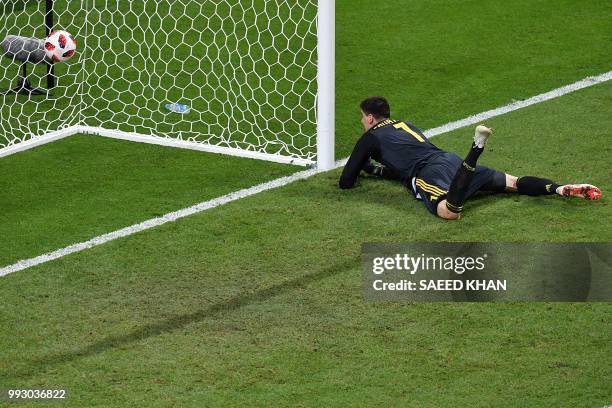 Belgium's goalkeeper Thibaut Courtois eyes the ball after conceding a goal during the Russia 2018 World Cup quarter-final football match between...