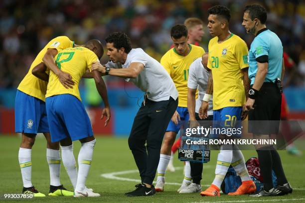 Brazil's midfielder Fernandinho receives medical assistance during the Russia 2018 World Cup quarter-final football match between Brazil and Belgium...