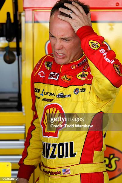 Kevin Harvick, driver of the Shell/Pennzoil Chevrolet, stands in the garage during practice for the NASCAR Sprint Cup Series Autism Speaks 400 at...