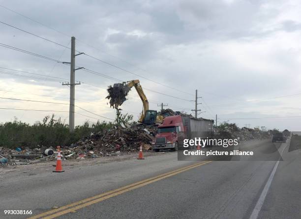 Bulldozer pours rubble left over from hurricane "Irma" into a truck along Highway No. By the island chains of the Florida Keys, USA. Even seven weeks...