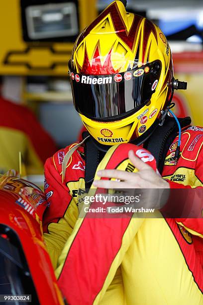 Kevin Harvick, driver of the Shell/Pennzoil Chevrolet, climbs in his car in the garage during practice for the NASCAR Sprint Cup Series Autism Speaks...