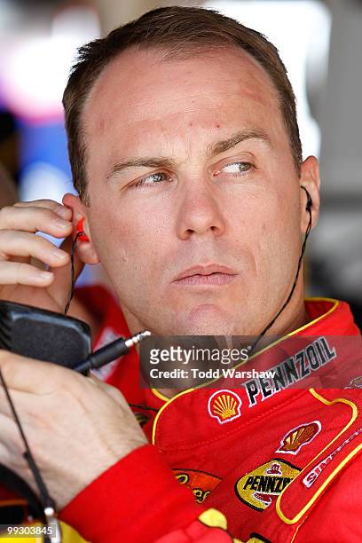 Kevin Harvick, driver of the Shell/Pennzoil Chevrolet, stands in the garage during practice for the NASCAR Sprint Cup Series Autism Speaks 400 at...