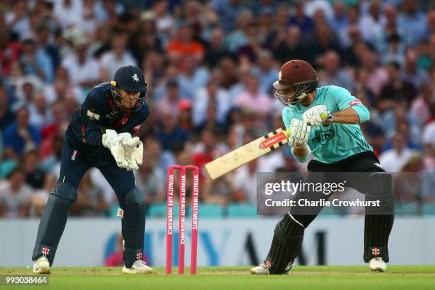 Ben Foakes of Surrey hits out while Sam Billings of Kent looks on during the Vitality Blast match between Surrey and Kent Spitfires at The Kia Oval...