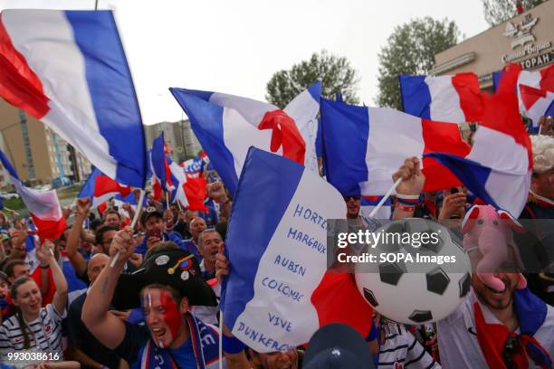 French football fans seen celebrating with their national flags. French football fans celebrate their national football team victory over uruguay...