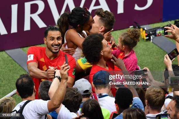 Belgium's defender Thomas Meunier shares a kiss with his girlfriend Deborah Panzokou at the end of the Russia 2018 World Cup quarter-final football...