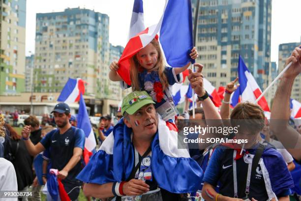 French football fan seen celebrating with his young daughter. French football fans celebrate their national football team victory over uruguay during...