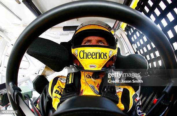 Clint Bowyer, driver of the Cheerios/Hamburger Helper Chevrolet, sits in his car in the garage area during practice for the NASCAR Sprint Cup Series...