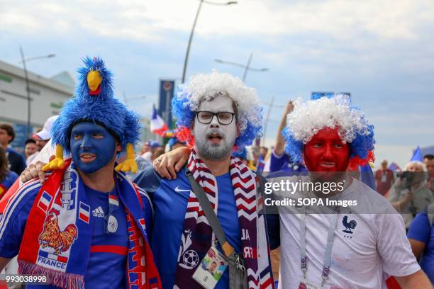 French football fans seen have his face painted with the french national flag's colour. French football fans celebrate their national football team...