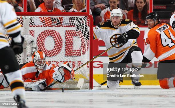 Michael Leighton and Kimmo Timonen of the Philadelphia Flyers stop a shot on goal by Michael Ryder of the Boston Bruins in Game Six of the Eastern...