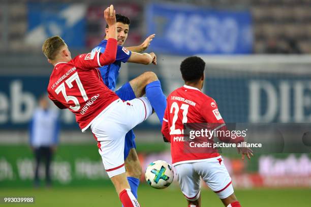 Kaiserslautern's Nicklas Shipnoski and Kaiserslautern's Phillipp Mwene in action against Bochum's Anthony Losilla during the German 2nd division...