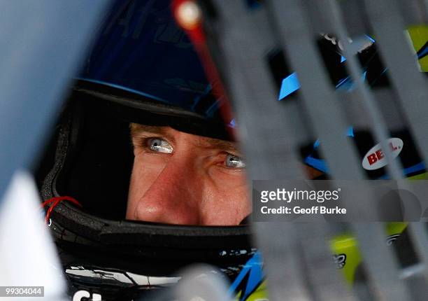 Carl Edwards, driver of the Aflac Ford, sits in his car in the garage during practice for the NASCAR Sprint Cup Series Autism Speaks 400 at Dover...