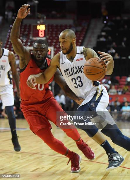 Garlon Green of the New Orleans Pelicans drives against Giddy Potts of the Toronto Raptors during the 2018 NBA Summer League at the Thomas & Mack...
