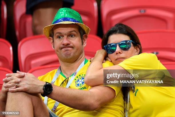Brazil supporters react to the defeat during the Russia 2018 World Cup quarter-final football match between Brazil and Belgium at the Kazan Arena in...