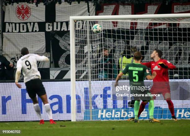 Frankfurt's Sebastien Haller scores the 2-1 goal against Bremen's Ludwig Augustinsson and goalkeeper Jiri Pavlenka during the German Bundesliga...