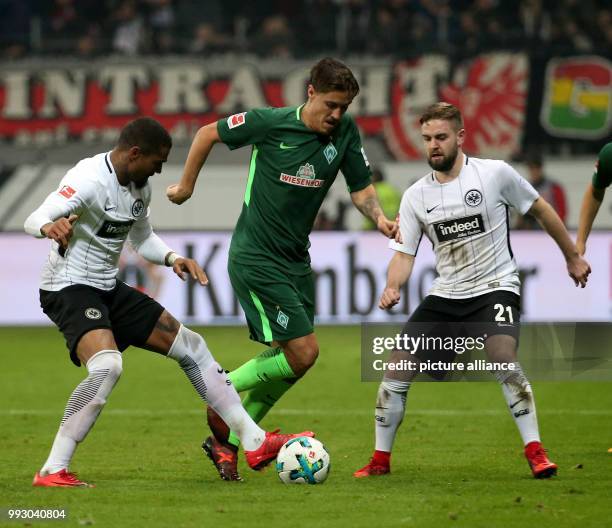Frankfurt's Kevin-Prince Boateng and Bremen's Max Kruse vie for the ball, Frankfurt's Marc Stendera on the right, during the German Bundesliga soccer...