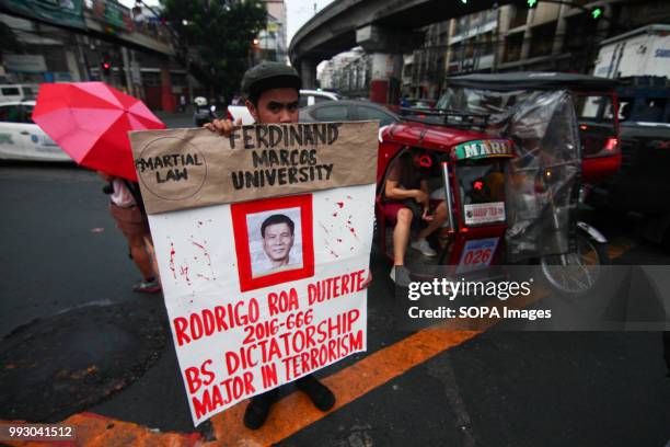 Youth students is seen holding a huge poster during the protest. Youth groups protest against the alleged human rights violation of the current...