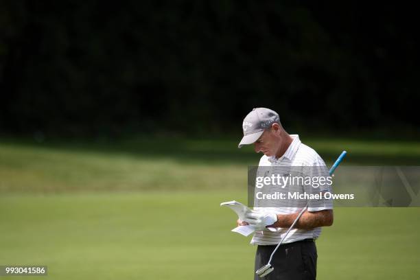 Jim Furyk checks his notes on the 12th hole during round two of A Military Tribute At The Greenbrier held at the Old White TPC course on July 6, 2018...