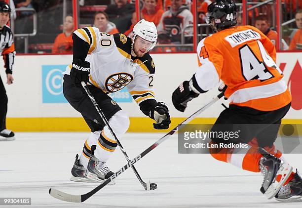 Daniel Paille of the Boston Bruins skates with the puck against Kimmo Timonen of the Philadelphia Flyers in Game Six of the Eastern Conference...