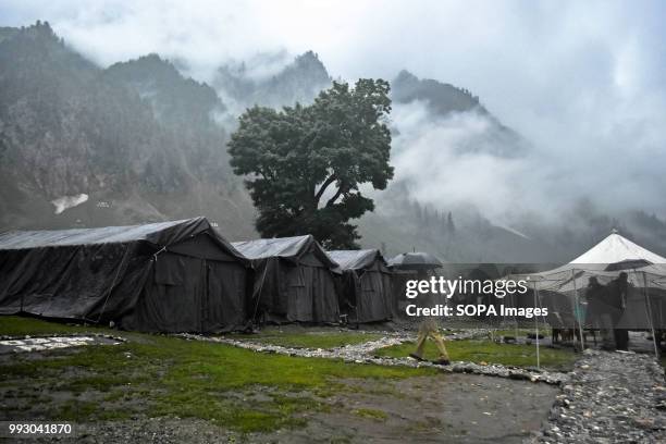 Hindu pilgrim walks near the temporary camps. Thousands of pilgrims annually go to the remote Himalayan shrine of Amarnath at 3,888 meters above sea...