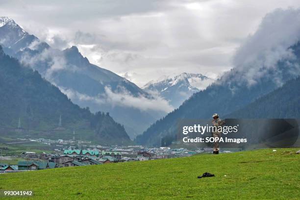 An Indian policeman keeps vigil during the traditional journey to the Amarnath cave. Thousands of pilgrims annually go to the remote Himalayan shrine...