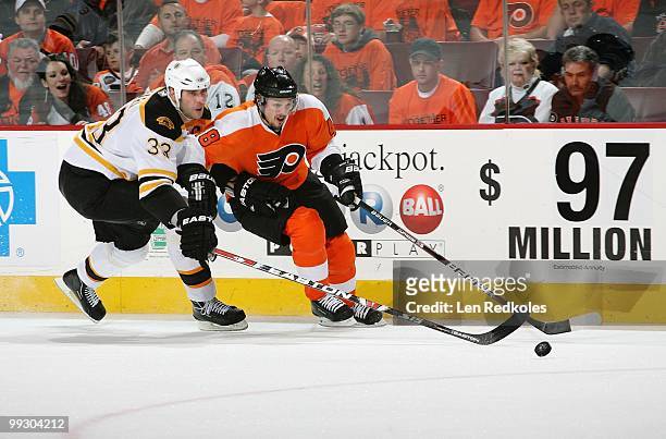 Danny Briere of the Philadelphia Flyers battles for the puck against Zdeno Chara of the Boston Bruins in Game Six of the Eastern Conference...