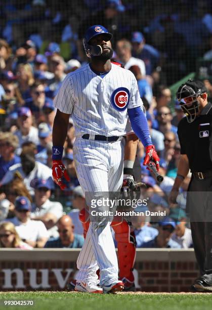 Jason Heyward of the Chicago Cubs walks back to the dugout after striking out in the 8th inning against the Cincinnati Reds at Wrigley Field on July...