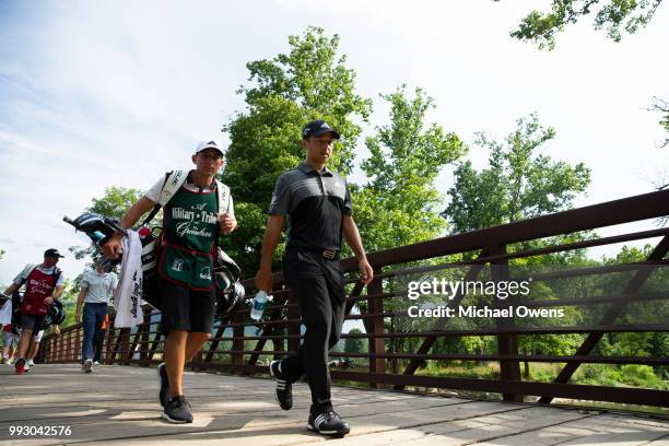 Xander Schauffele walks to his second shot on the 17th hole during round two of A Military Tribute At The Greenbrier held at the Old White TPC course...