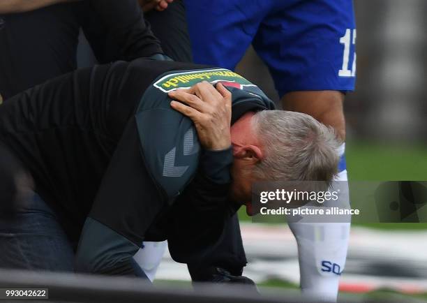 Freiburg's coach Christian Streich seen after a player brought him down during the German Bundesliga soccer match between SC Freiburg and FC Schalke...