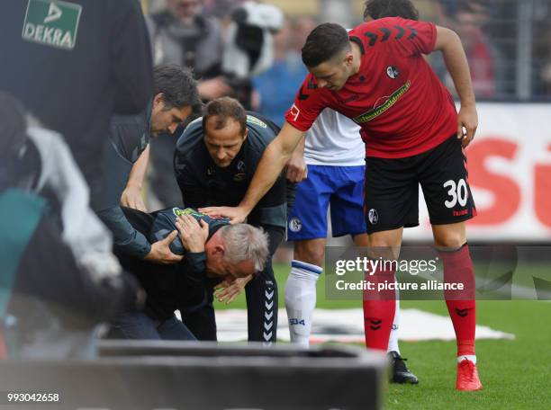 Freiburg's coach Christian Streich seen after a player brought him down during the German Bundesliga soccer match between SC Freiburg and FC Schalke...