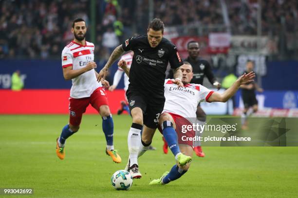 Hamburg's Kyriakos Papadopoulos and Stuttgart's Daniel Ginczek vie for the ball during the German Bundesliga soccer match between Hamburger SV and...