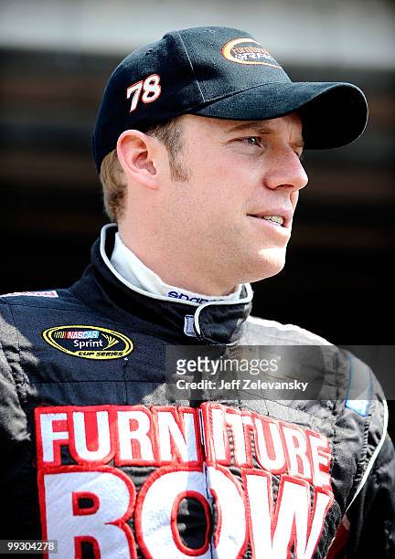 Regan Smith, driver of the Furniture Row Racing Chevrolet, stands in the garage during practice for the NASCAR Sprint Cup Series Autism Speaks 400 at...