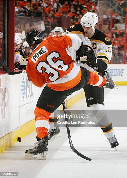 Zdeno Chara of the Boston Bruins checks Darroll Powe of the Philadelphia Flyers in Game Six of the Eastern Conference Semifinals during the 2010 NHL...