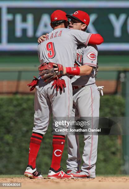 Jose Peraza and Scooter Gennett of the Cincinnati Reds hug after a win against the Chicago Cubs at Wrigley Field on July 6, 2018 in Chicago,...