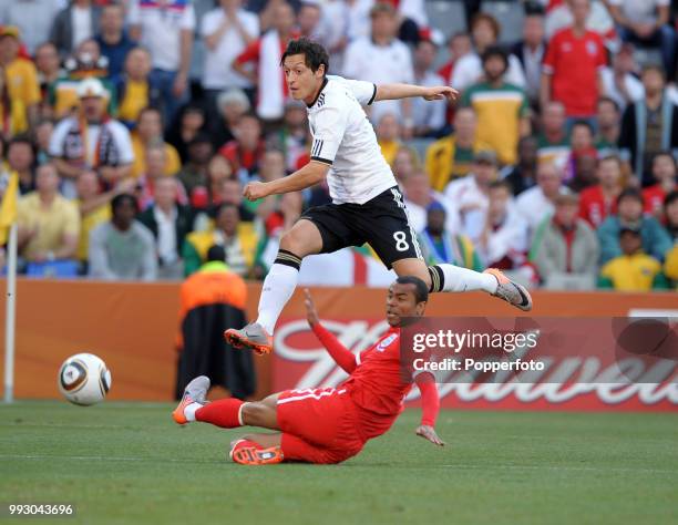 Ashley Cole of England attempts to block a shot from Mesut Ozil of Germany during a FIFA World Cup Round of 16 match at the Free State Stadium on...