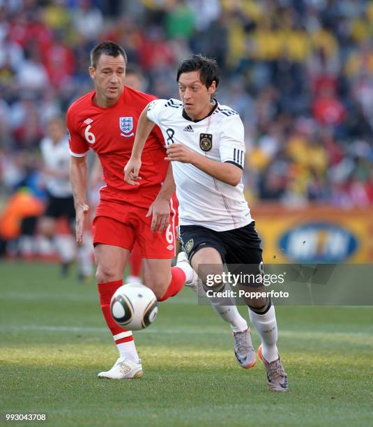 Mesut Ozil of Germany goes past John Terry of England during a FIFA World Cup Round of 16 match at the Free State Stadium on June 27, 2010 in...