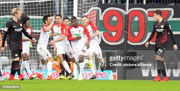 Augsburg's Caiuby, Ja-Cheol Koo, Rani Khedira, Kevin Danso and Jeffrey Gouweleeuw celebrate the final 1-1 goal during the German Bundesliga soccer...