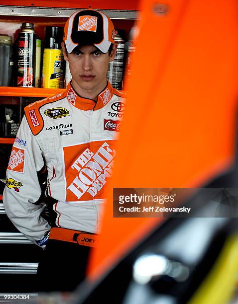 Joey Logano, driver of the The Home Depot Toyota, stands in the garage during practice for the NASCAR Sprint Cup Series Autism Speaks 400 at Dover...